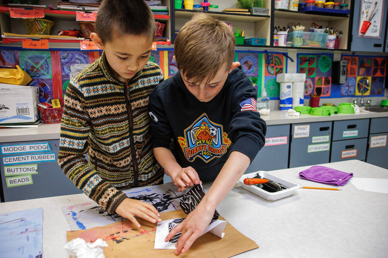 Photo by David Welton
Fourth graders Dante Churchill, left, and Alex Kukuk demonstrate how to make block prints of Salish Sea creatures during a recent art class. The prints will be available for sale at the upcoming student-led art gala at South Whidbey Elementary School.
