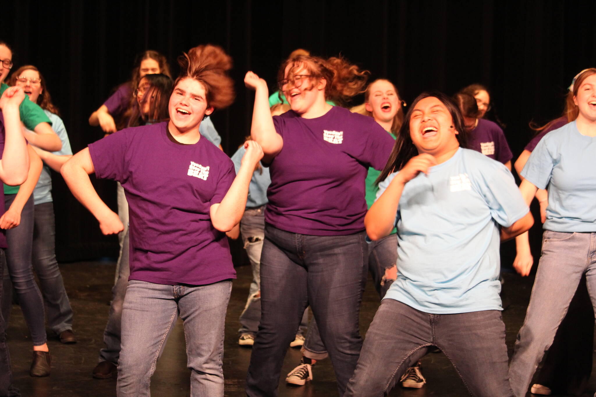From left, Ash Davis, Alora Van Auken and Jomhel Mendoza dance with the cast in “You Can’t Stop the Beat” from “Hairspray.” (Photo by Karina Andrew/Whidbey News-Times)