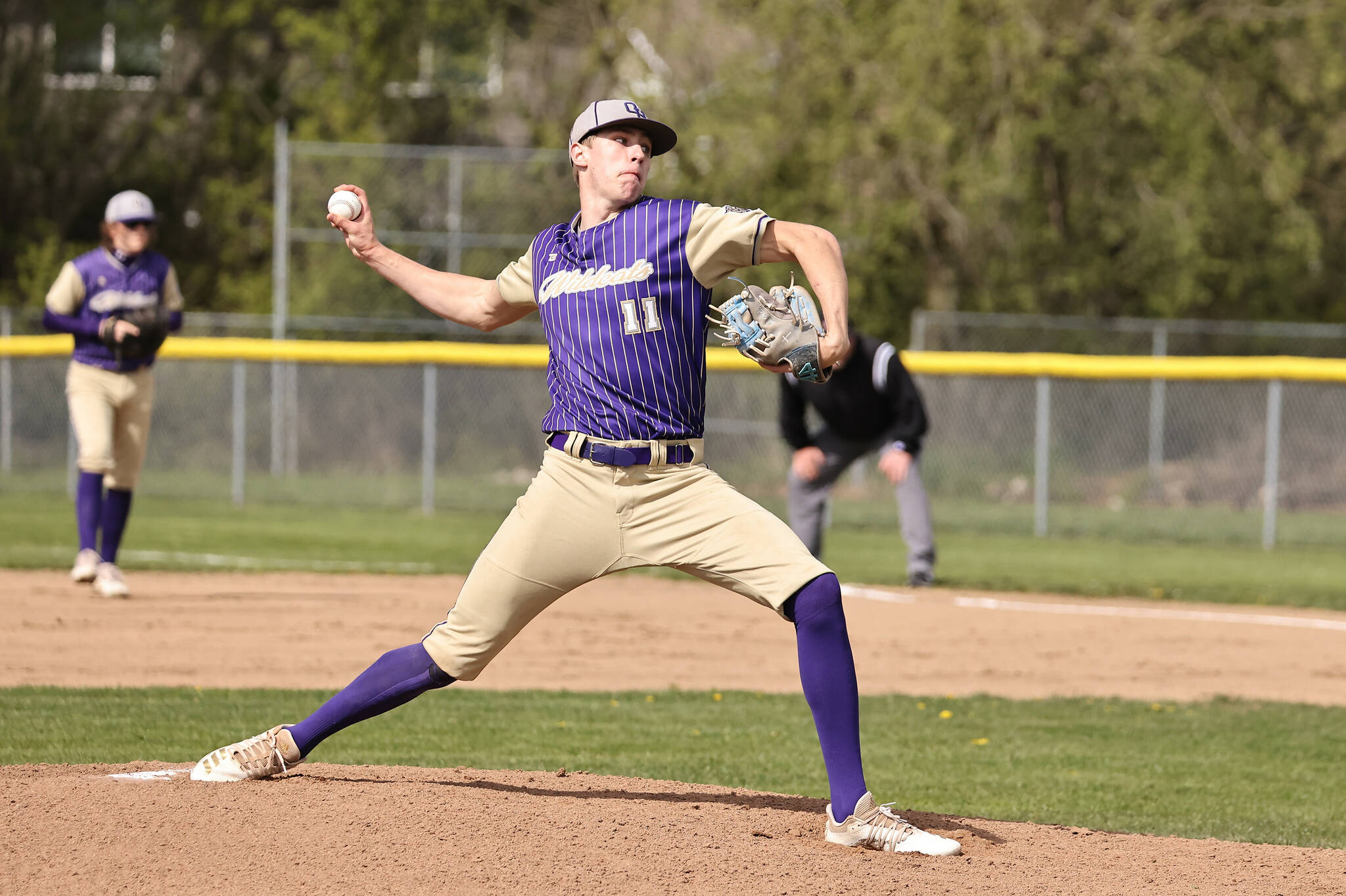 Oak Harbor High School student Luke Vrable pitches. (Photo by John Fisken)