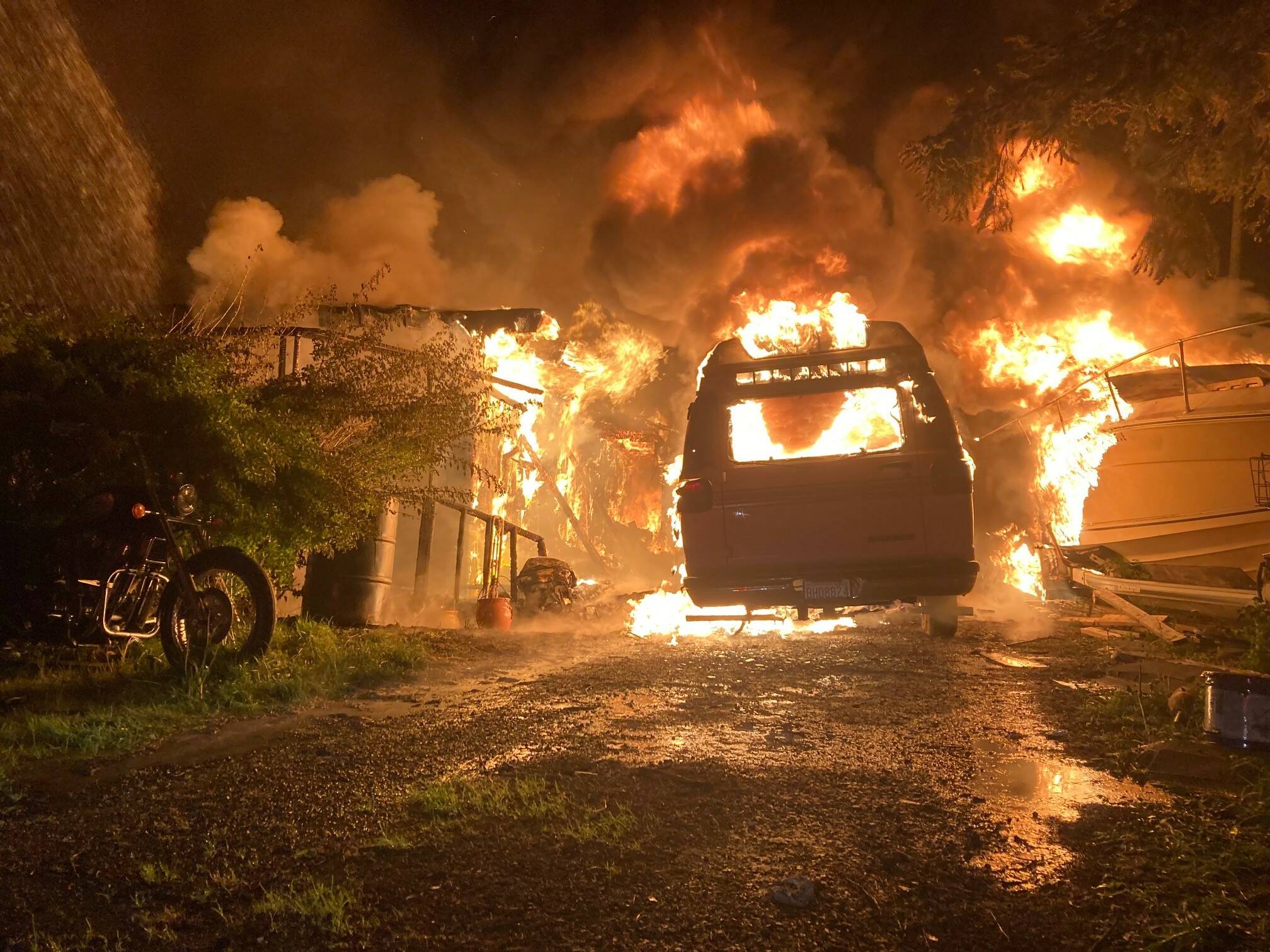 A residential fire engulfs a North Whidbey home, two vans and a boat early Thursday morning. (Photo by North Whidbey Fire and Rescue)