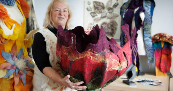 Fiber artist Janet King holds an enormous felt creation she refers to as a “vessel.” King is one of the participating artists on the Whidbey Art Trail this year. (Photo by David Welton)