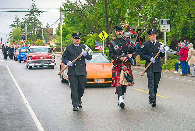 Central Whidbey Fire and Rescue Captain Jerry Helm plays bagpipes down the parade route. (2016 File Photo by Pam Headridge.)