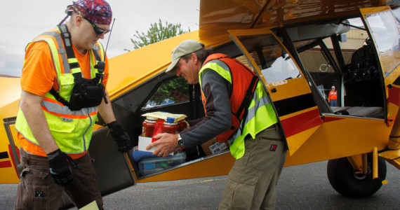 Photo By David Welton
Volunteers unload food donations from an airplane.