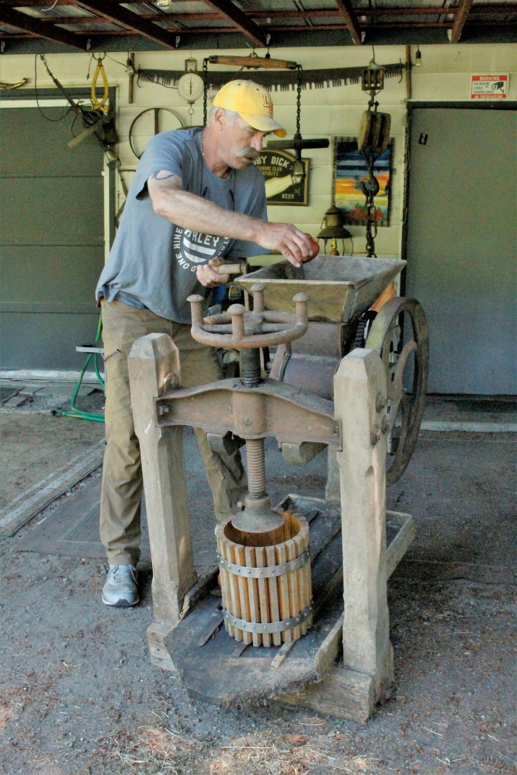 Photo by Kira Erickson/South Whidbey Record
South Whidbey picker John Norris demonstrates how to use an old fruit press he found while exploring a family farm. He has plans to donate the artifact to the South Whidbey Historical Society, which will put it on display for fairgoers to see this year.