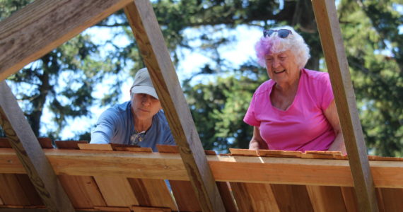 Volunteers build a roof in the style of the early 1900s on the Pratt Machine Shed in Ebey’s Landing National Historical Reserve. (Photo by Karina Andrew/Whidbey News-Times)
