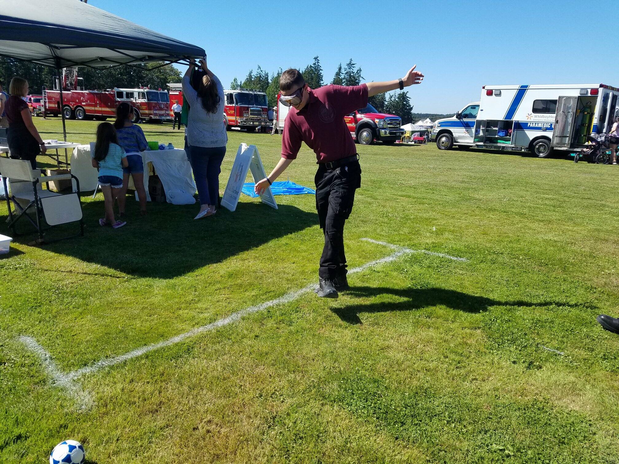 A participant wearing fatal vision goggles attempts to walk in a straight line at last year’s National Night Out. (Photo provided by Oak Harbor Police Department)