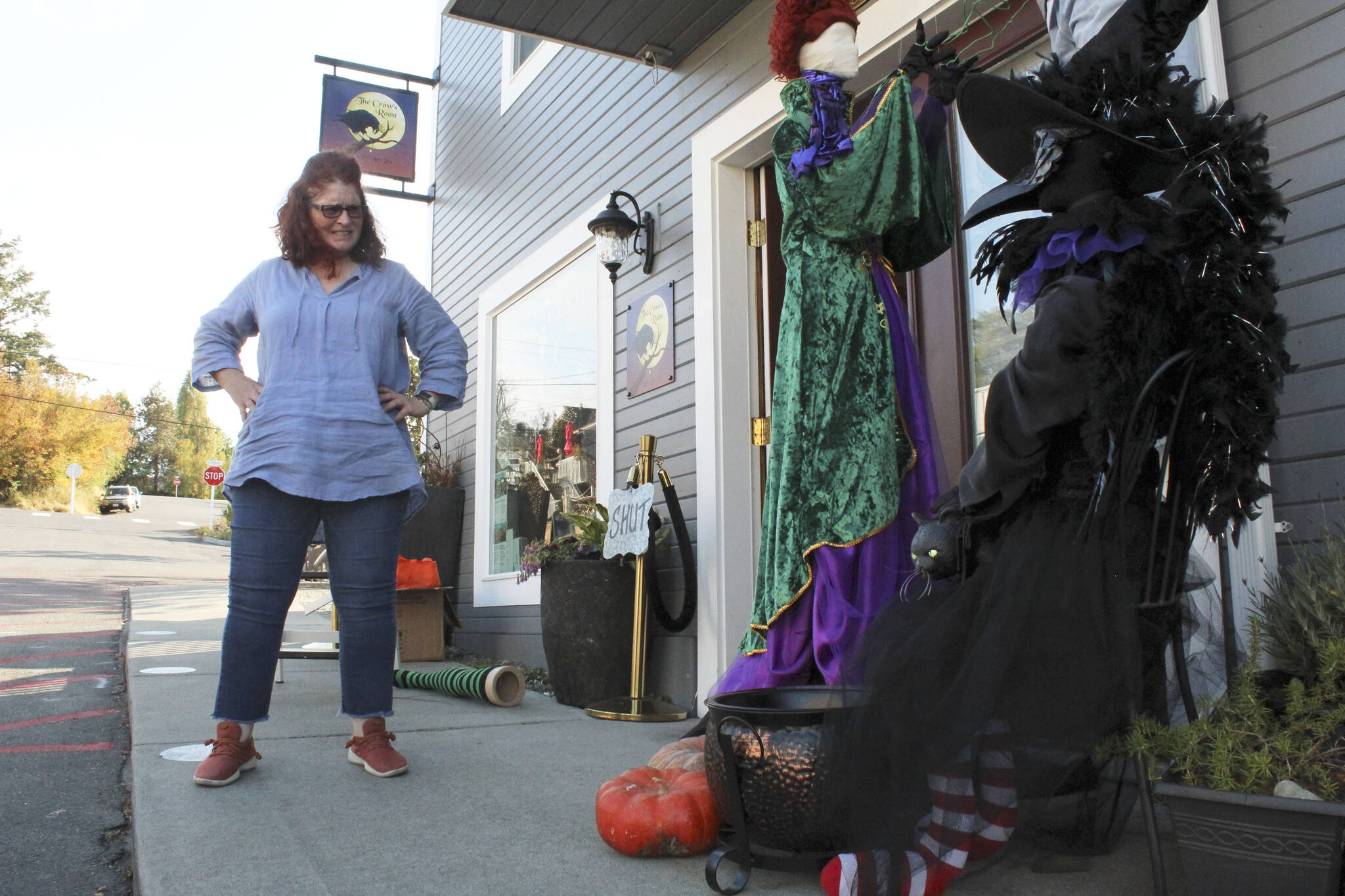 Photo by Karina Andrew/Whidbey News-Times
Mel Rodman sets up a “Hocus Pocus” themed display outside her business, Crow’s Roost. She is one of more than twenty business owners participating in this year’s Scarecrow Trail, part of the annual Haunting of Coupeville.