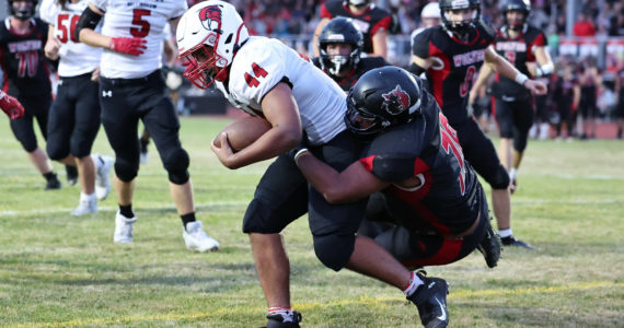 Photo by John Fisken
Coupeville athlete Josh Upchurch tackles a Bellingham player. The Coupeville High School varsity football team demolished Bellingham 48-6 before a sellout crowd Thursday. The victory lifts Coupeville to 5-1 this season.