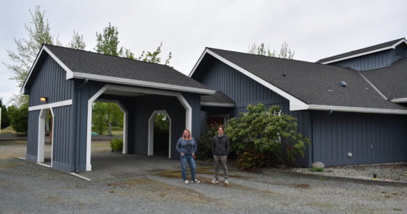 File photo
Officials from the Whidbey Homeless Coalition stand in front of the former Jehovah’s Witness Church in Central Whidbey that is being turned into a emergency homeless shelter.