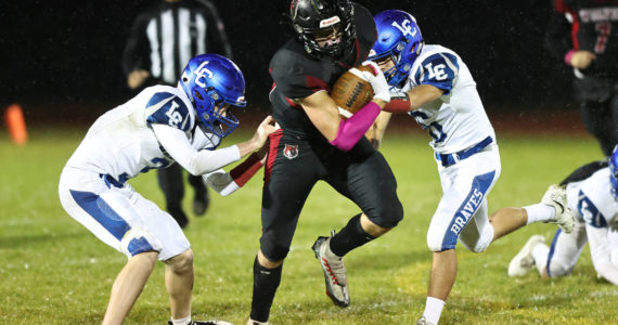 Photo be John Fisken
Coupeville High School senior running back Dominic Coffman rips through La Conner tacklers on his way to a big gain in Friday’s 78-0 win. Coffman leads the Wolves in rushing yards this season, and is third on the team with nine touchdowns.