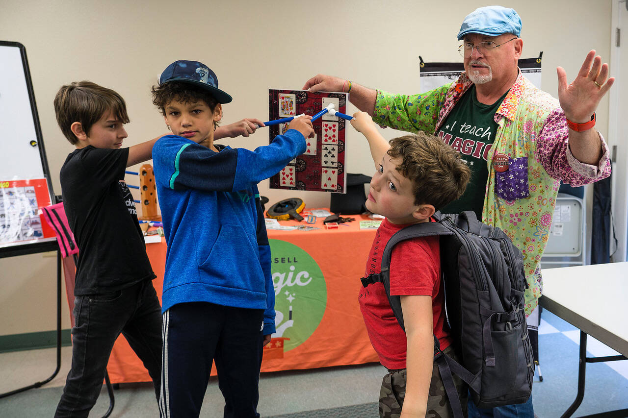 Photo by David Welton
From left to right, Cam Peloetier, 10, Miles Guggenheim, 9, and Dylan Gluckman-Oskin, 7, point to a card on the board that was chosen.