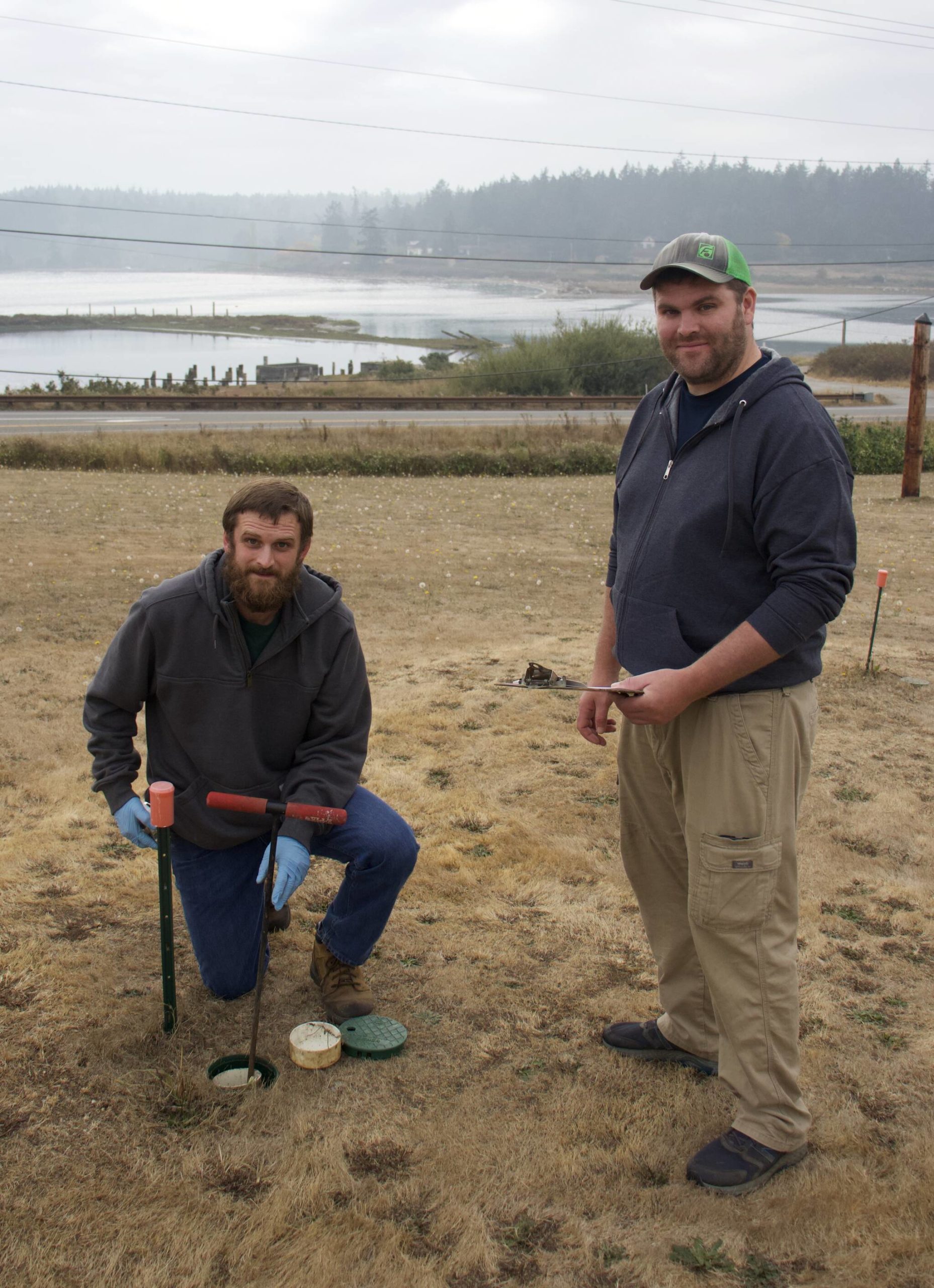 Photo by Rachel Rosen/Whidbey News-Times
Ben Miller (left) and his brother Seth (right) own Whidbey Septic. Seth is inspecting the final part of a home’s septic system; the last stop before wastewater enters the groundwater.