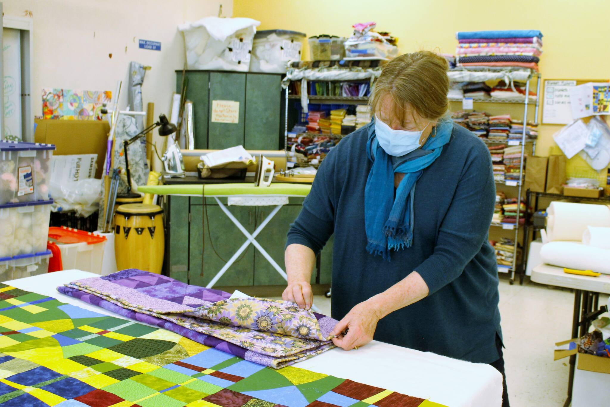 File photo/South Whidbey Record
Luanne Seymour, photographed here in 2021, shows a few different-sized quilts that Whidbey Blanket Makers sewed. The group continues to meet at Create Space.