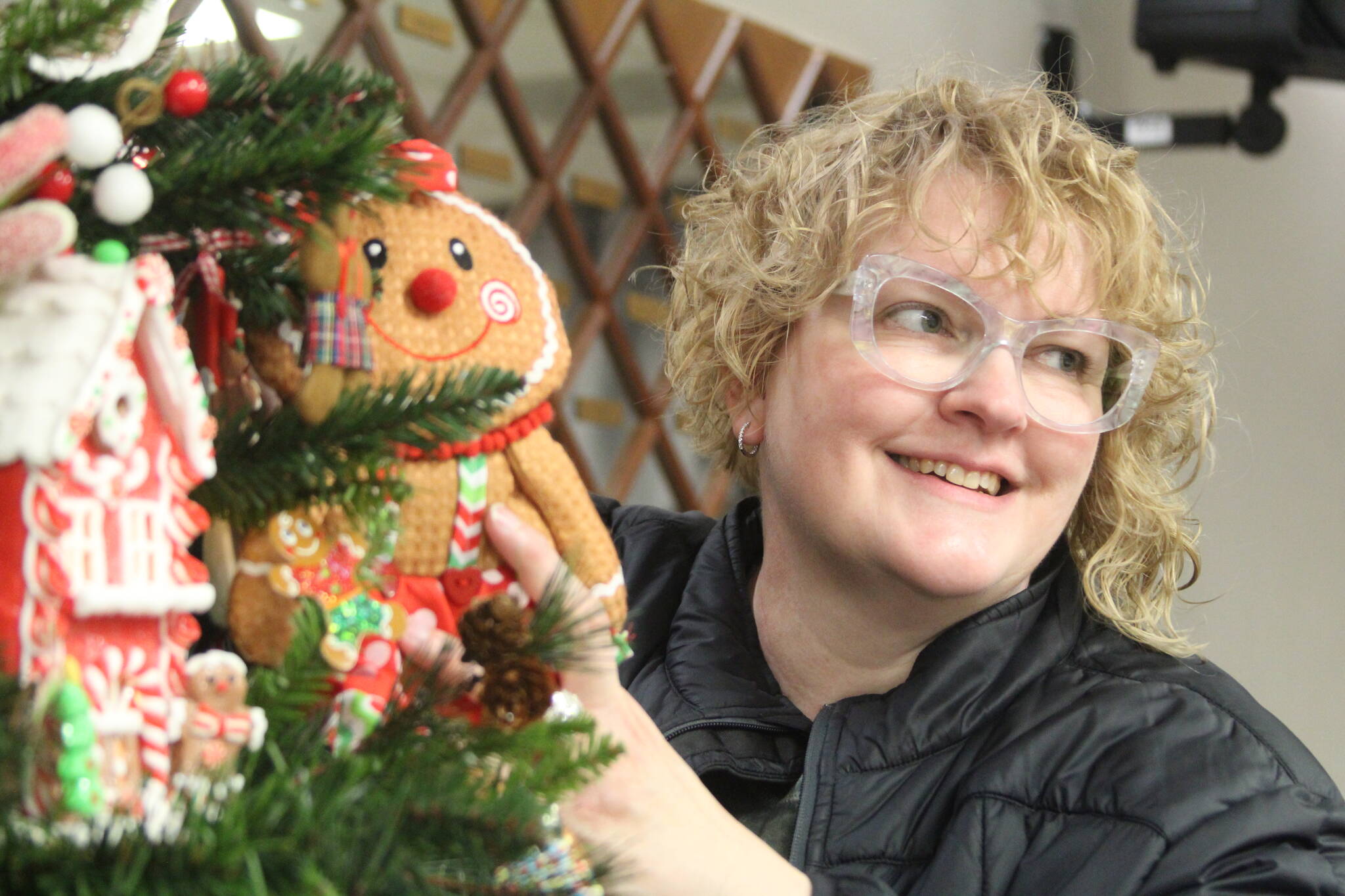 Photo by Karina Andrew/Whidbey News-Times
Decorating coordinator Hope McCormack puts a finishing touch on a gingerbread-themed tree.