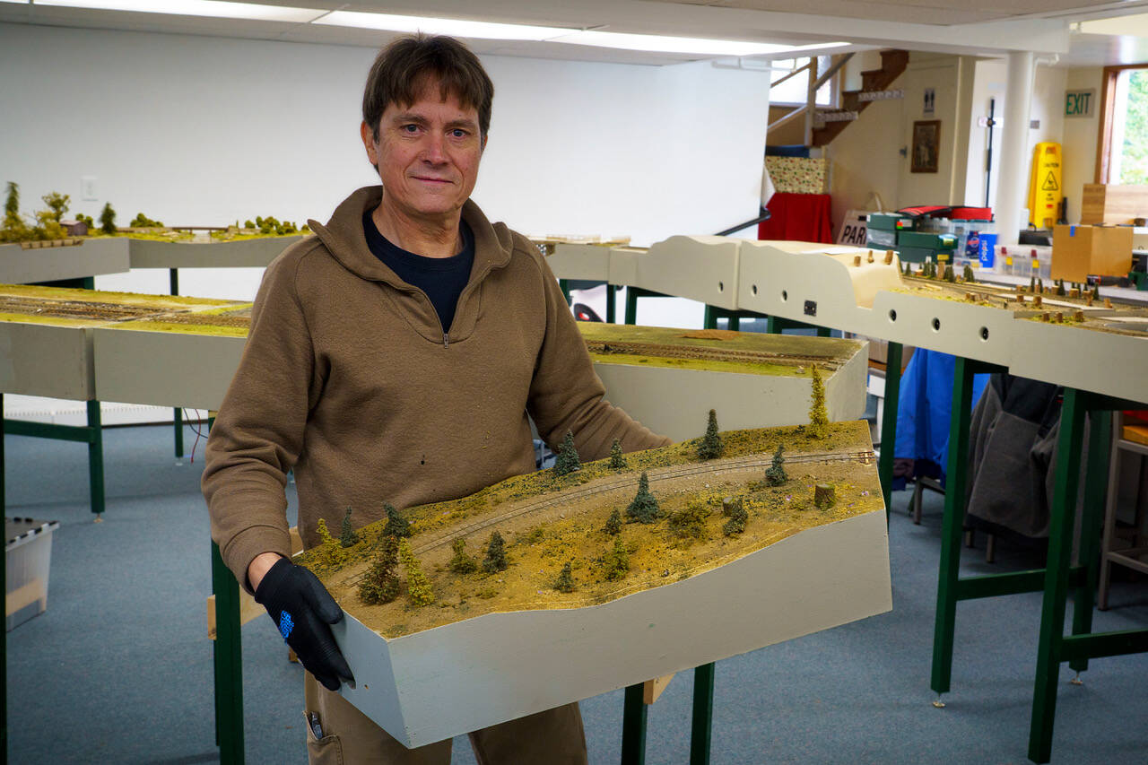 Photo by David Welton
Rich Blake carries a module during set-up of the train show at the Little Brown Church. A total of 26 modules are connected together to create the model railroad.