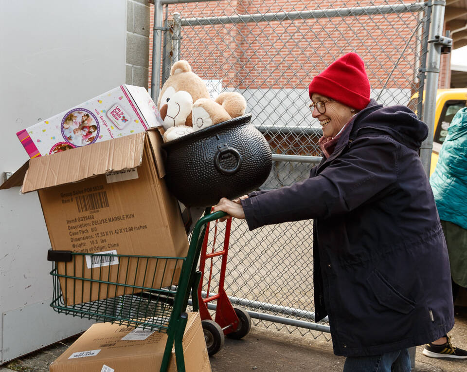 Photo provided
A volunteer wheels a cart full of donations into Holiday House.