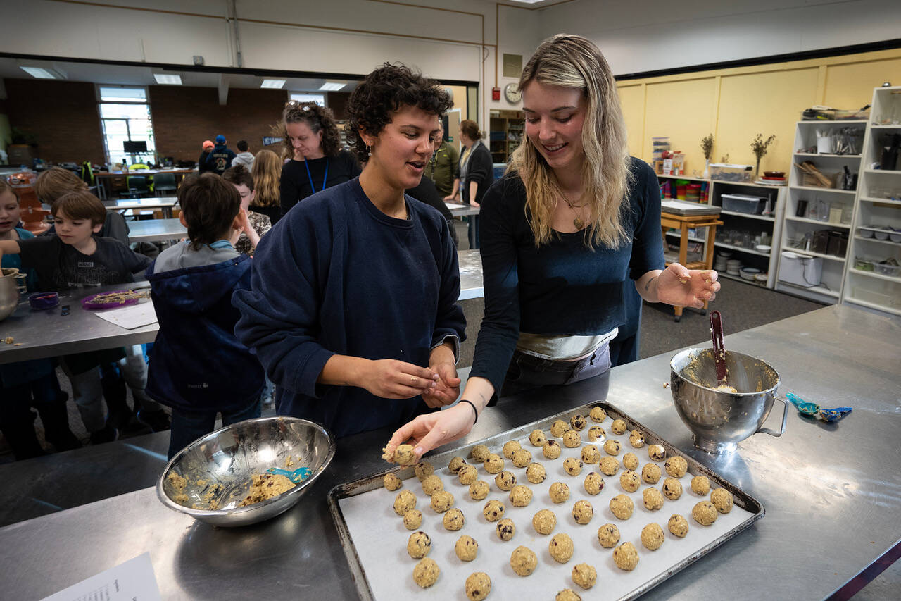 Photo by David Welton
AmeriCorps members Grace Adam, left, and Circe Skaife roll out the dough for cookies made during South Whidbey Elementary School’s MLK Day of Service.
