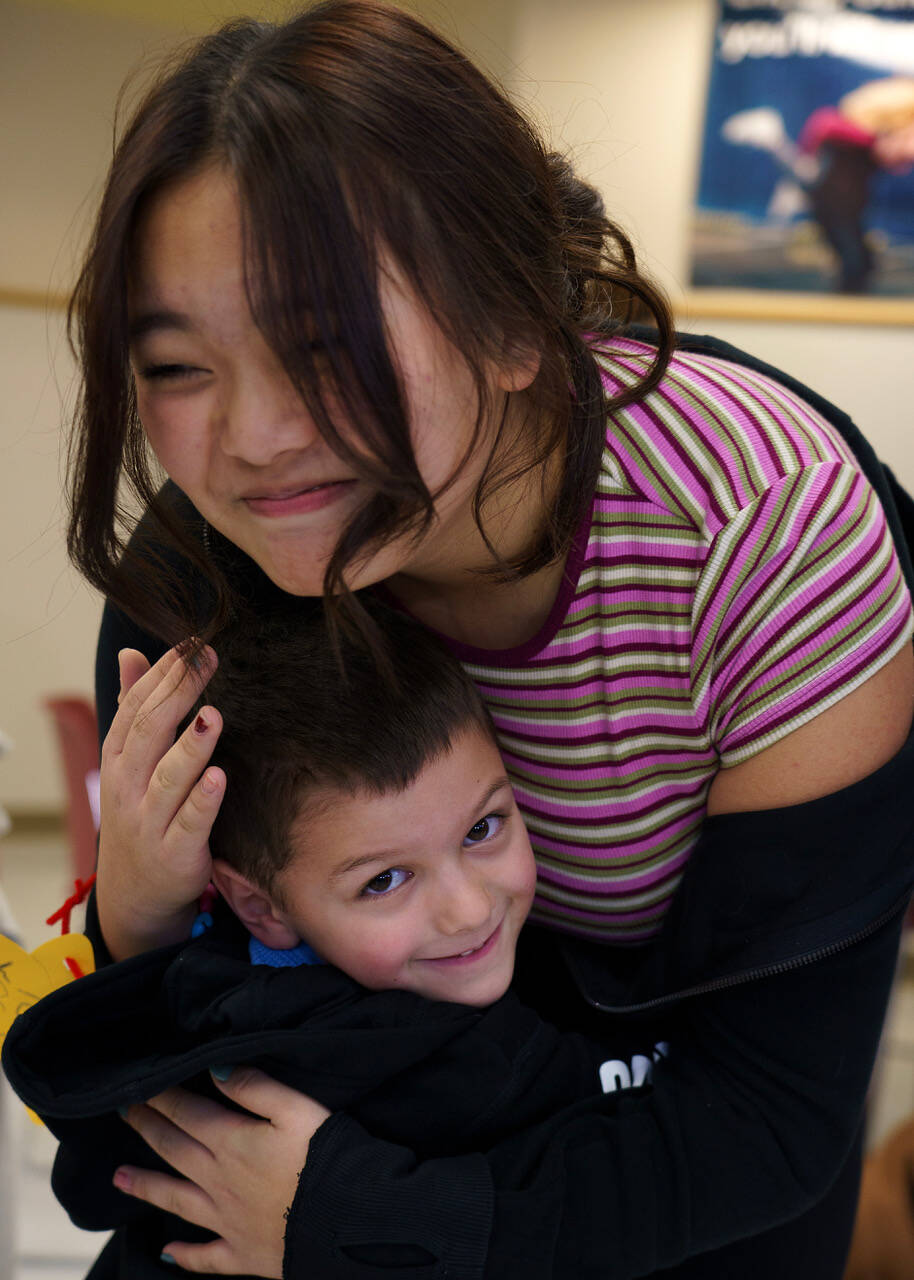 Photo by David Welton
Senior Dolma Doryang shares a hug with kindergartener Cruz Kelly.