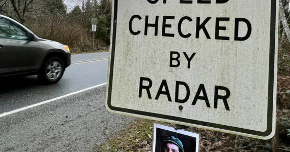 A photo of “M*A*S*H” character Corporal Walter "Radar" O’Reilly has mysteriously returned to the “Speed Checked by Radar” sign on Third Street coming into Langley on Whidbey Island on Jan. 2, 2023. (Andrea Brown / The Herald)