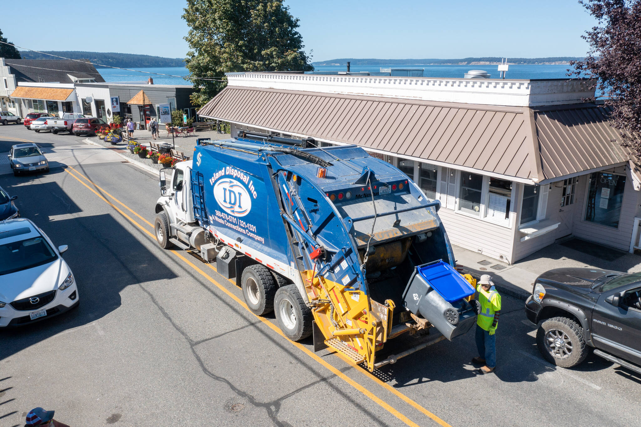 Island Disposal workers pick up the recycling in downtown Langley. Commercial customers can now receive expanded recycling services. (Photo provided)