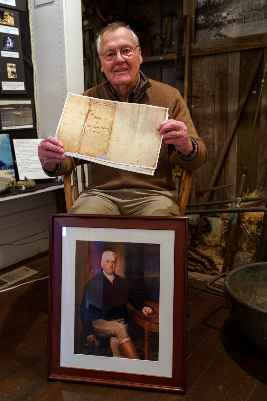 Photo by David Welton
South Whidbey Historical Society President William Haroldson proudly holds a paper copy of Whidbey’s will. He has been studying Whidbey’s life for the past 20 years, and even brought back a reprint of a portrait of the naval explorer from England in 2003.
