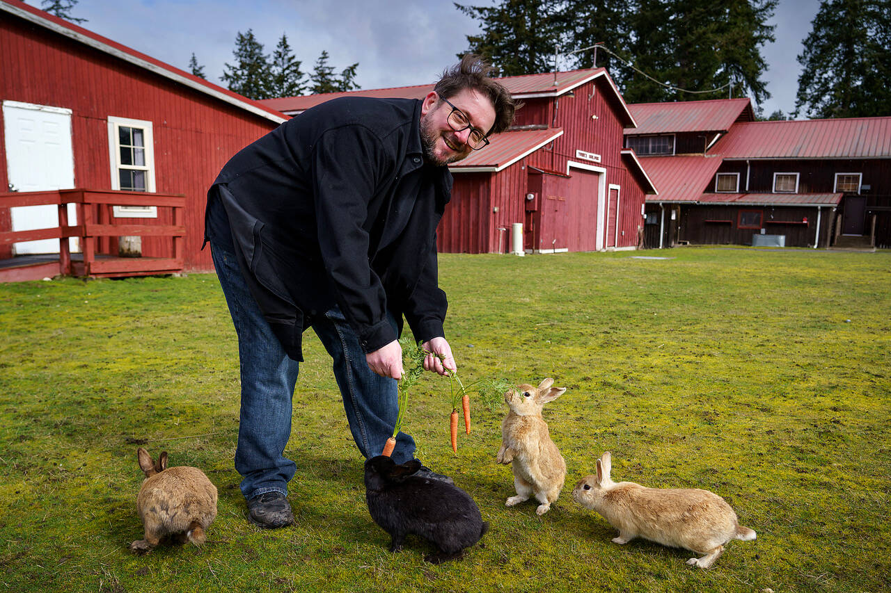 Photo by David Welton
Derrick Sutton feeds the furry denizens of Langley, who are featured in his book, “The Day of the Jackalope.”