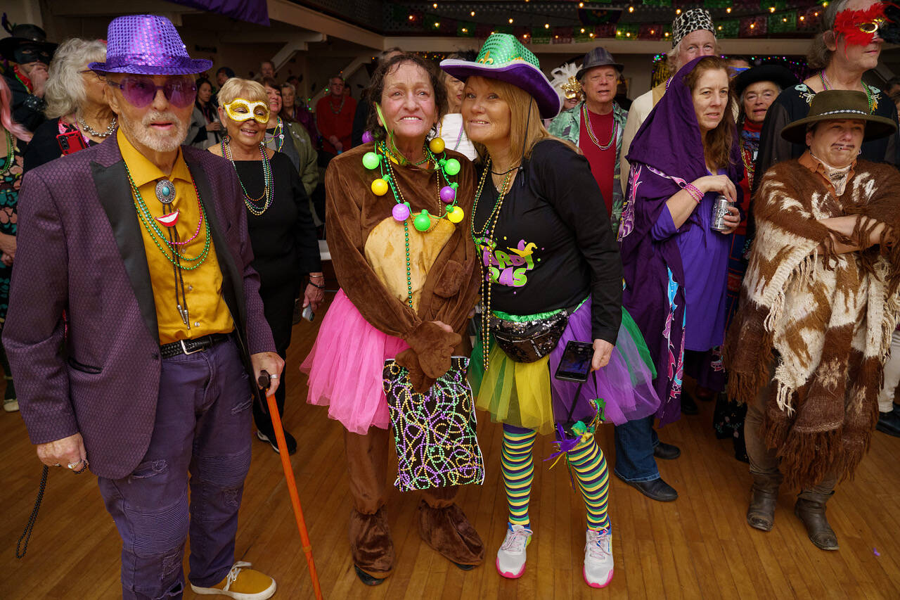 Party-goers at the Mardi Gras Ball at Bayview Hall on Tuesday danced and swayed to live music from Janie Cribbs and the T.Rust Band. Many adorned themselves with the signature purples, yellows and greens of the day, while others chose different costumes entirely to wear to the event.