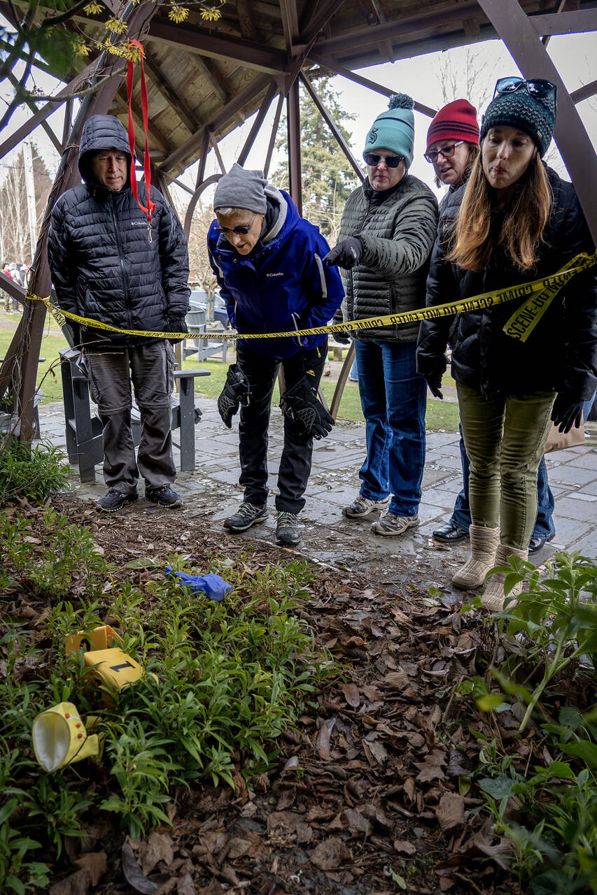 Mystery Weekend participants peered at the scene of the crime, which was located at Langley Park this year.