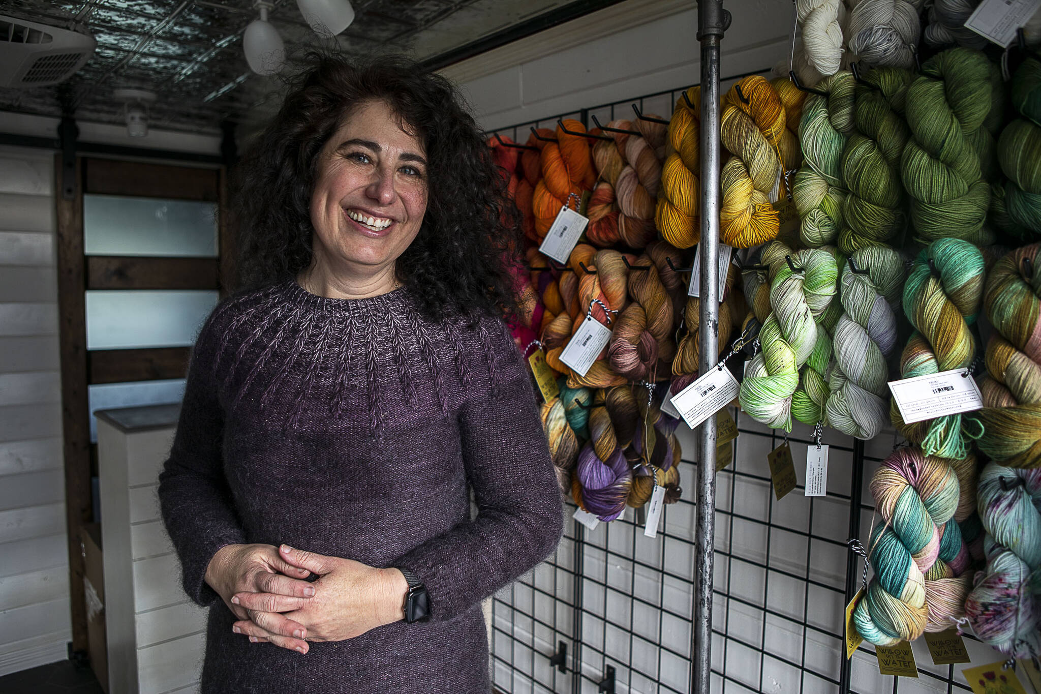 Willow Mietus, 50, stands inside “The Wool Wagon.” (Annie Barker / The Herald)