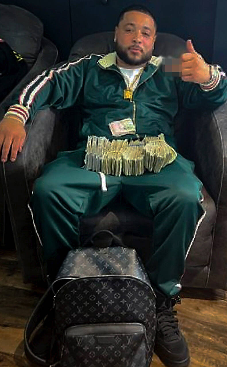 Courtesy of FBI
Federal agents obtained a “selfie” photo of Bryce Hill with piles of cash through a search warrant of his phone.