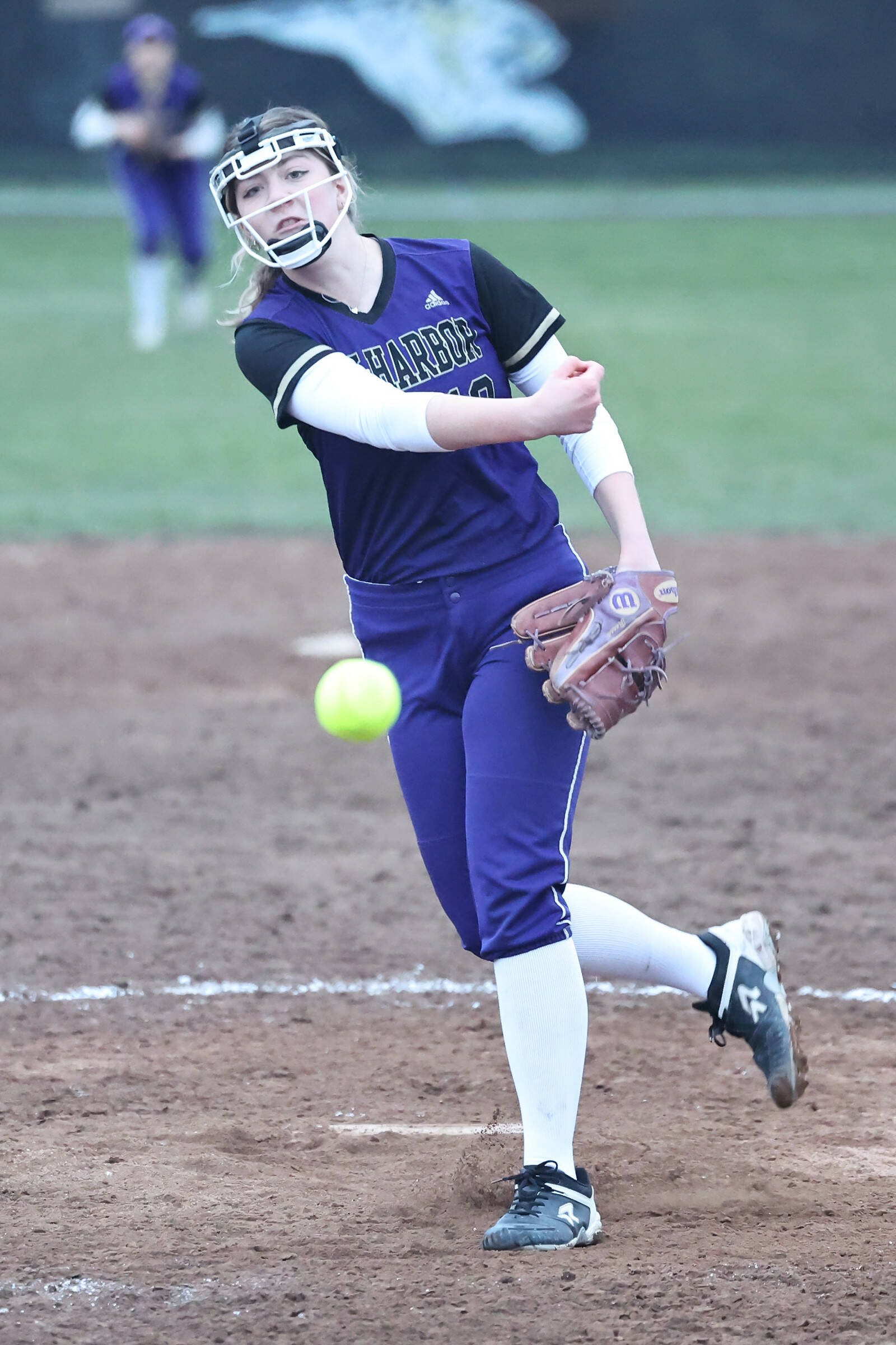 Oak Harbor athlete Reese Wasinger throws the ball during a varsity softball game March 10. Wasinger claimed the win as the pitcher, striking out three batters, allowing one hit and one earned run.