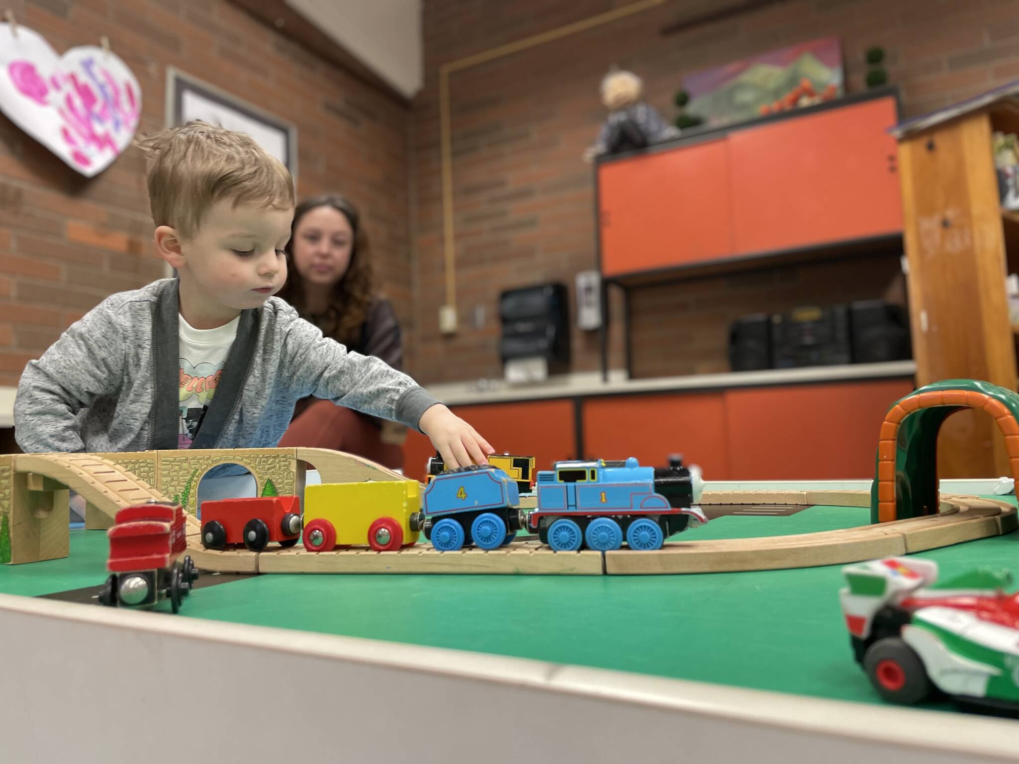 Photo provided
Ewan, 2, plays with a train at Playscape while his mom Lindsey McCoy watches.
