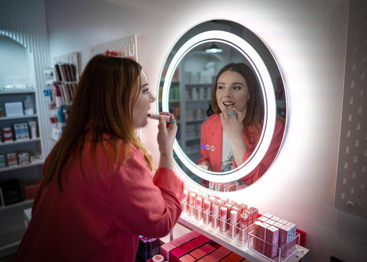Sarah Jean Muncey-Gordon applies a fresh coat of lipstick at Bandbox Beauty Supply, her new store in Langley. Customers can find cruelty-free and predominantly vegan cosmetics, fragrances, skin, body and nail care products that adhere to the European Union’s chemical safety standards for beauty products. (Photo by David Welton)