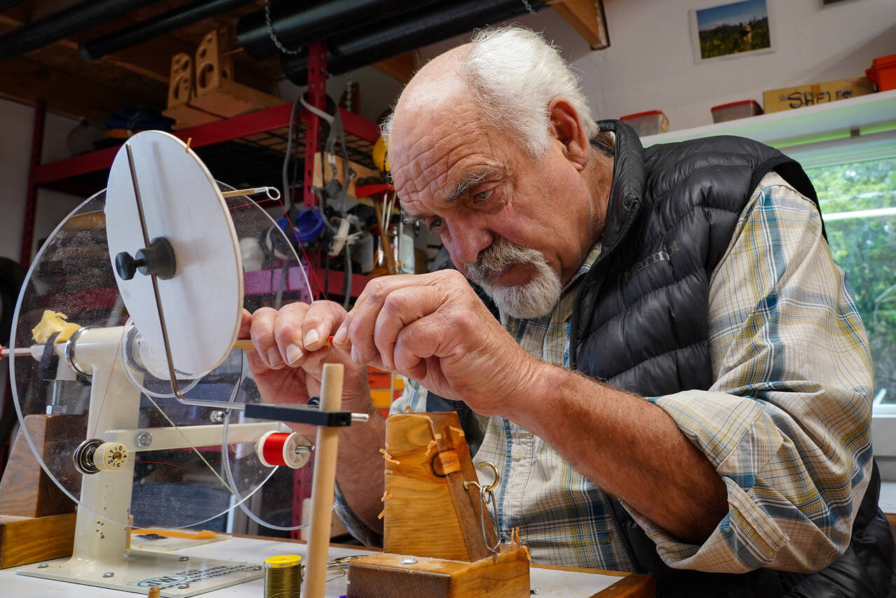 Jon Lyman works on a segment of a fly fishing rod in his workshop. For nearly 25 years, Lyman has built custom bamboo rods that honor of legacy of anglers. (Photo by David Welton)