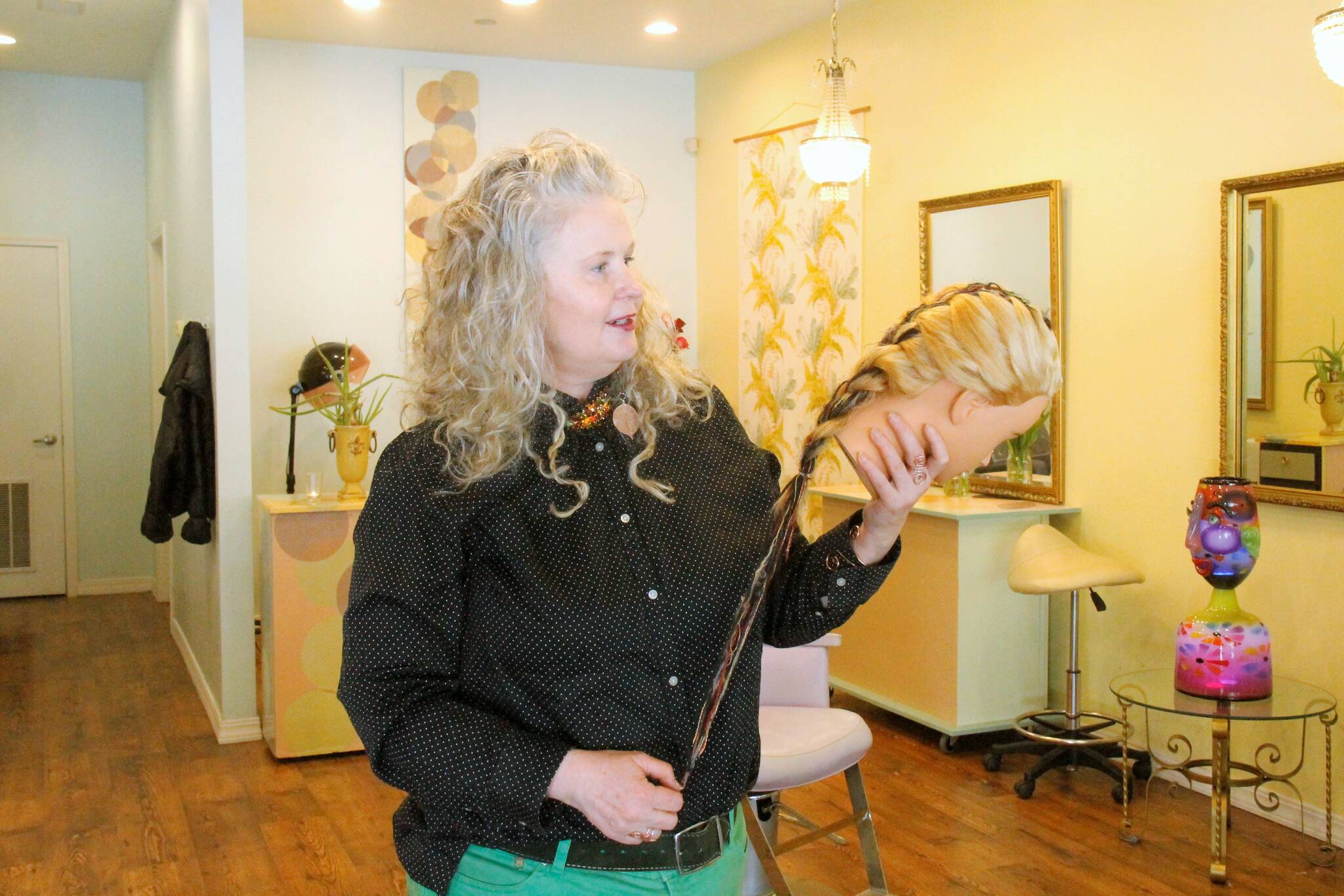 Alison Donham demonstrates what she calls “fantasy hair,” a blend of yarns that can be braided into someone’s hair as an accessory. (Photo by Kira Erickson/South Whidbey Record)