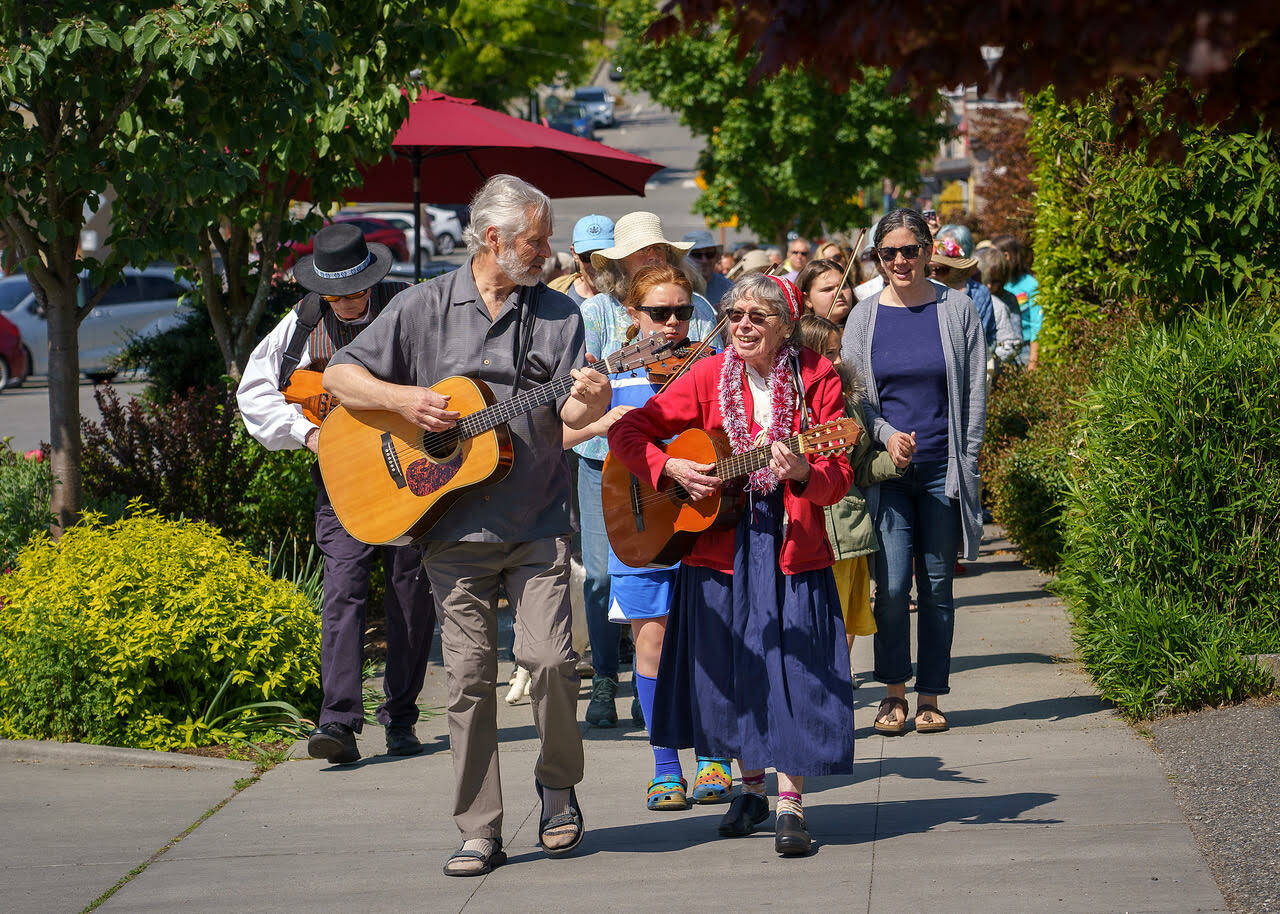 Karl Olsen and Linda Good led an improvised street parade in Langley. (Photo by David Welton)