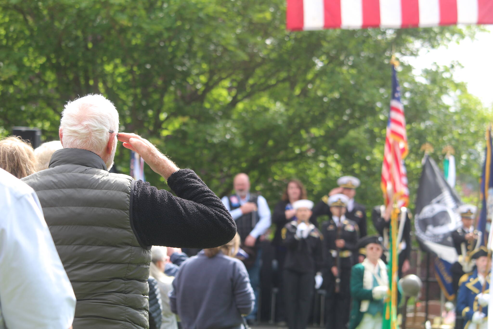 Photo by Karina Andrew/Whidbey News-Times
A member of the crowd at an Oak Harbor Memorial Day service salutes the flag.