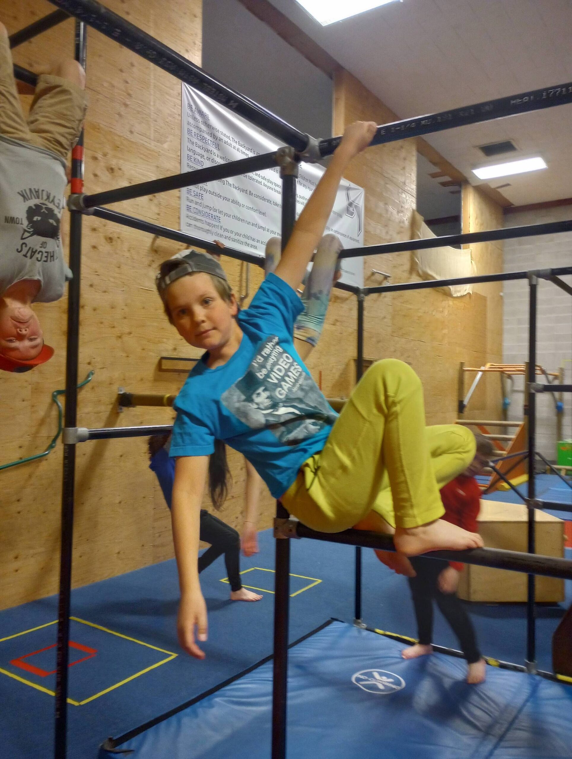 Sam Courteau hangs from the jungle gym at The Backyard. (Photo provided)