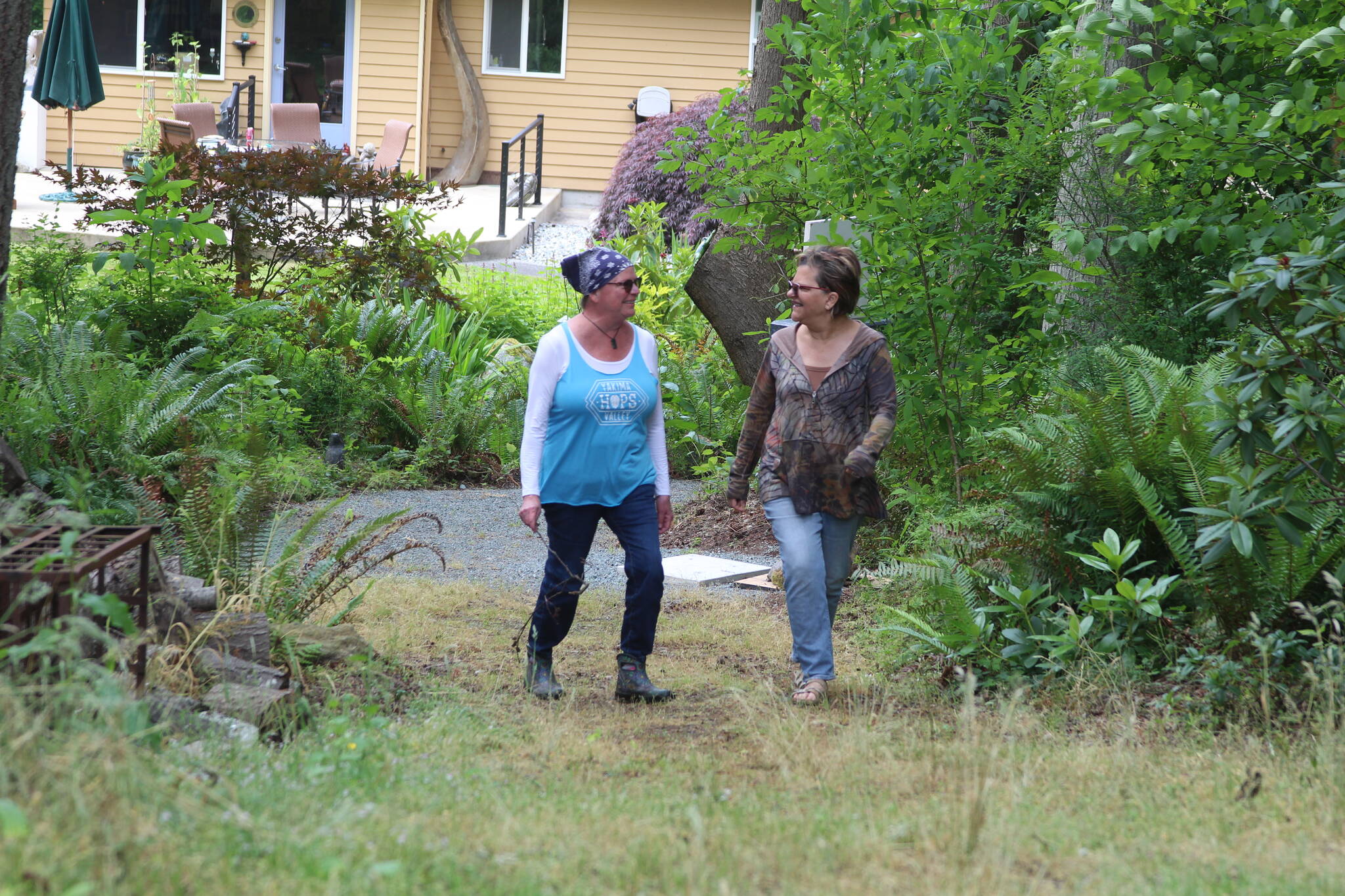 Photo by Karina Andrew/Whidbey News-Times
Therese Kingsbury and Robin Boyle walk the trails at the Whidbey Island Sculpture Experience, Kingsbury’s sculpture garden.