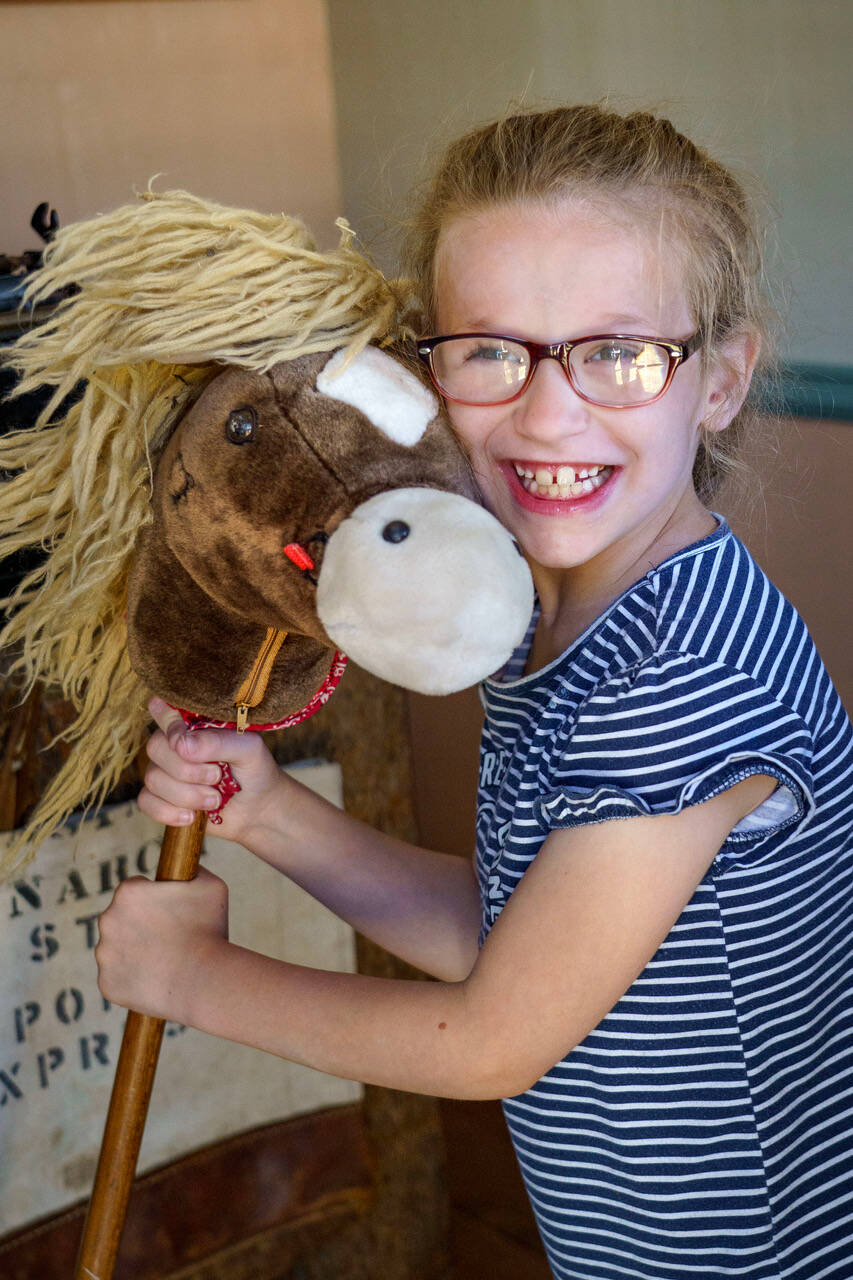 Second grader London Connell poses with a stick horse. (Photo by David Welton)