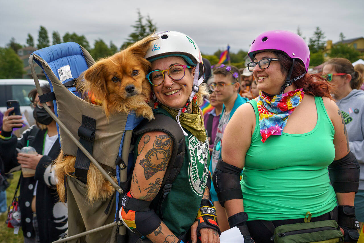 Lui Steph, at left, brought her dog to participate in the Coupeville Pride Parade Saturday with fellow skater Alex Necro. (Photo by David Welton)