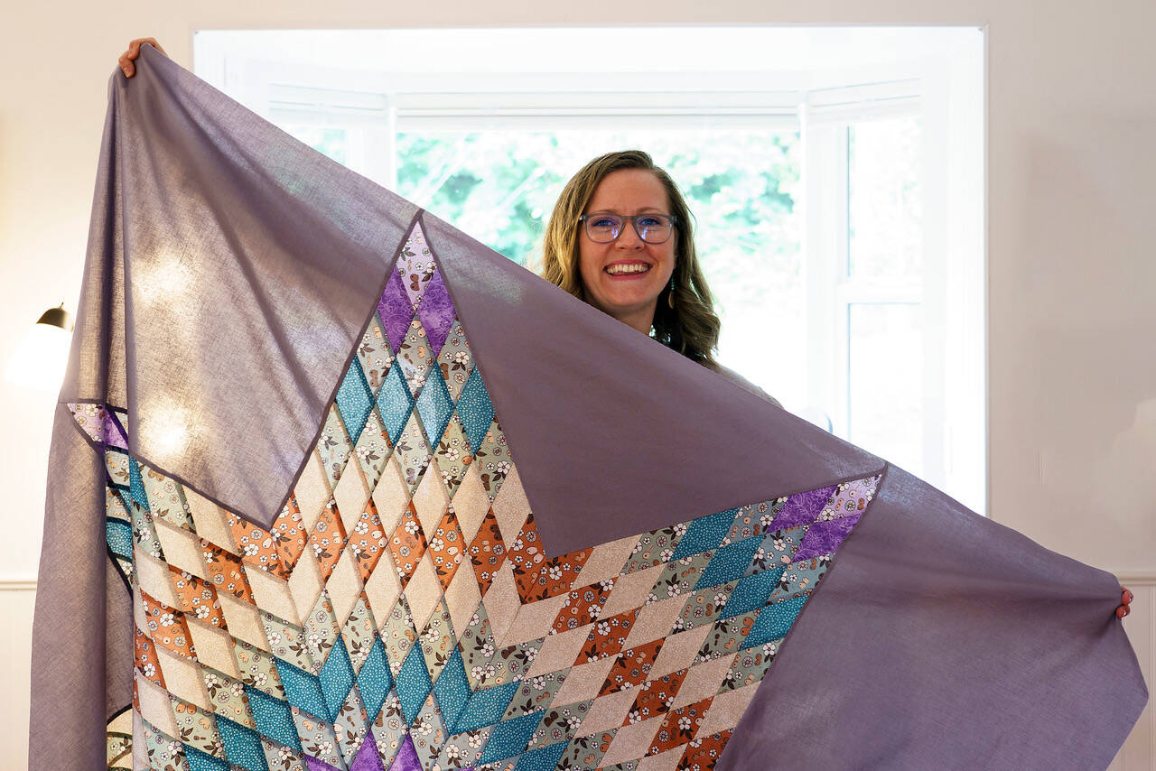 A quilter, Emily Grubb can make a blanket representing the couple’s colors for their wedding. (Photo by David Welton)