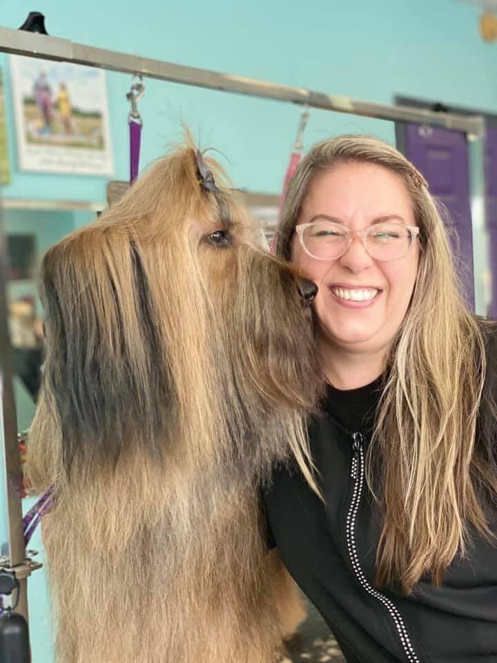 Reyna Hull-Walton gets a kiss from Zara at Posh Puppies. (Photo provided)