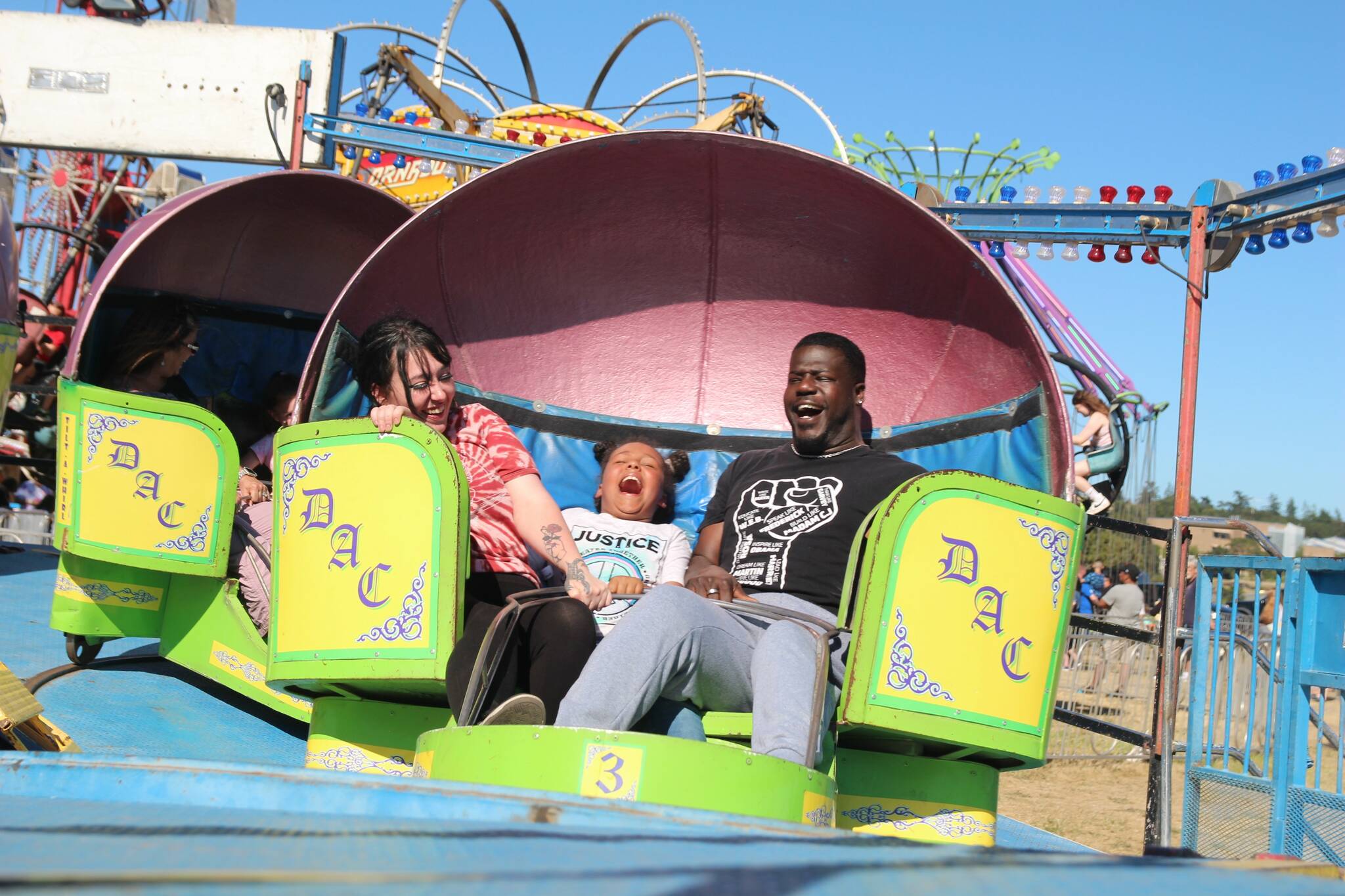 A family has fun spinning at the carnival. (Photo by Luisa Loi / Whidbey News-Times)