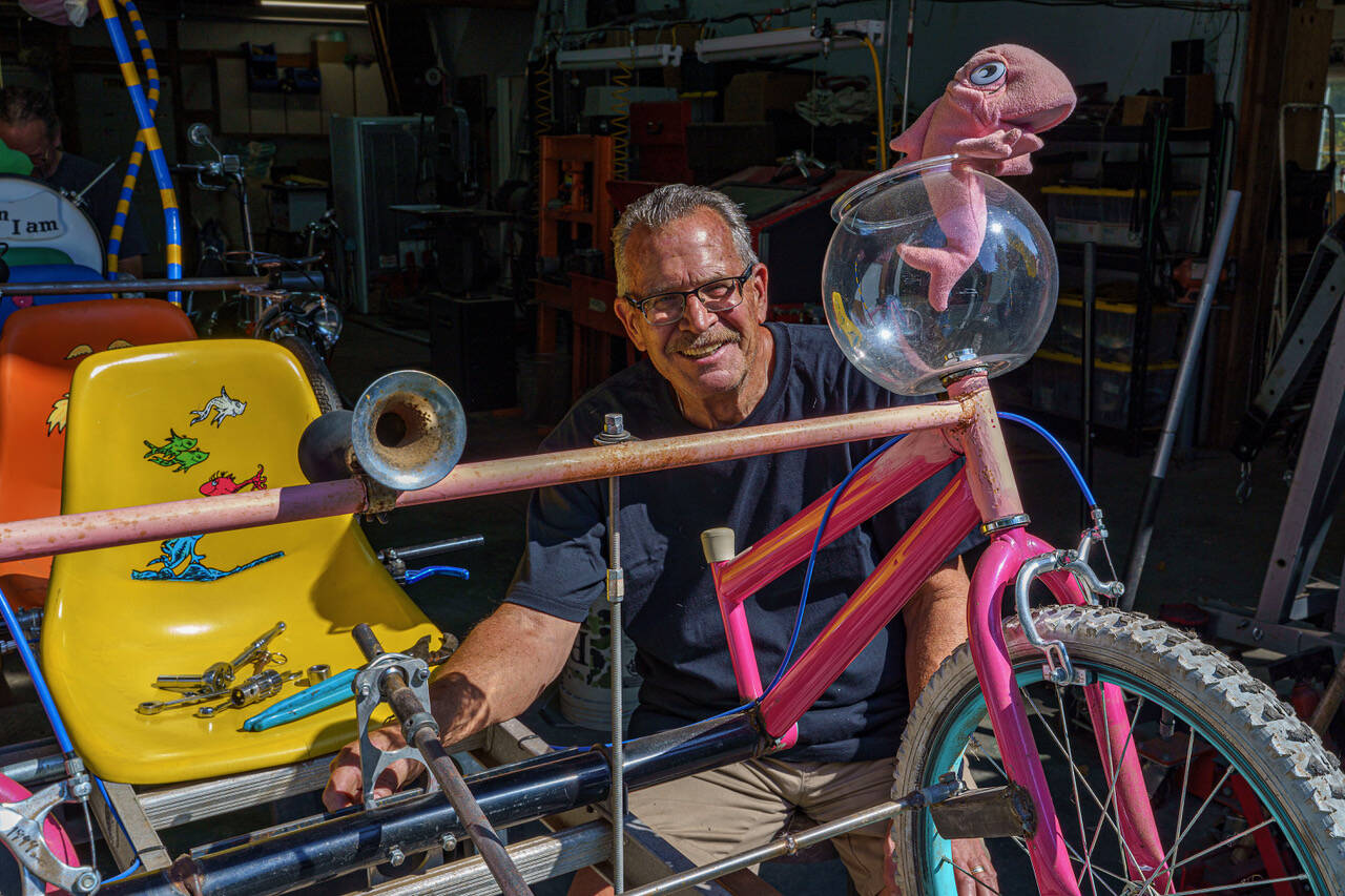 Tim Callison, a regular racer in the Soup Box Derby, makes some modifications to his vehicle, which has a Dr. Seuss theme. (Photo by David Welton)