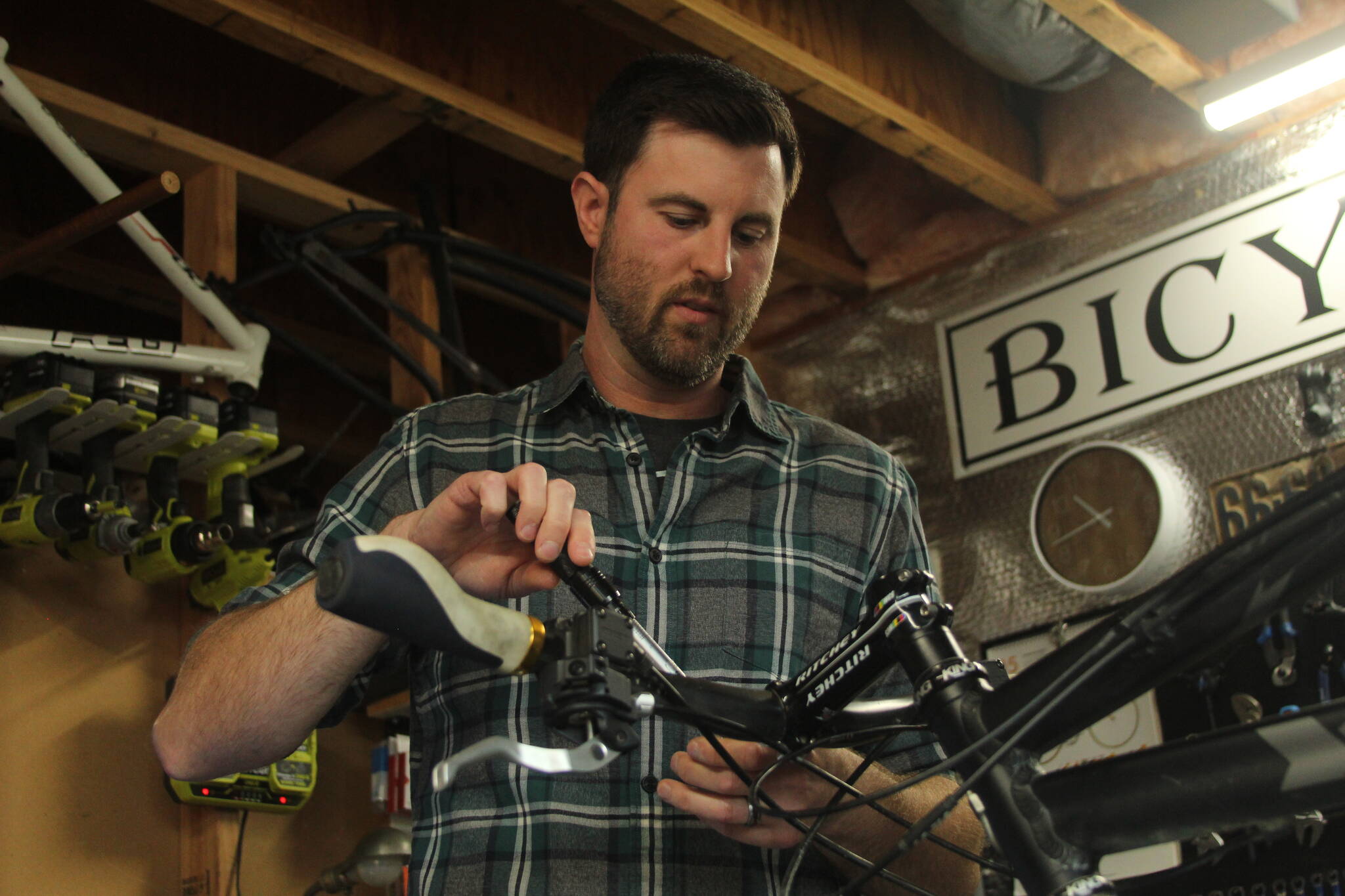 Photo by Karina Andrew/Whidbey News-Times
Trevor Stevens, owner of Celerity Cycles, fixes a bicycle in his home shop in Coupeville.