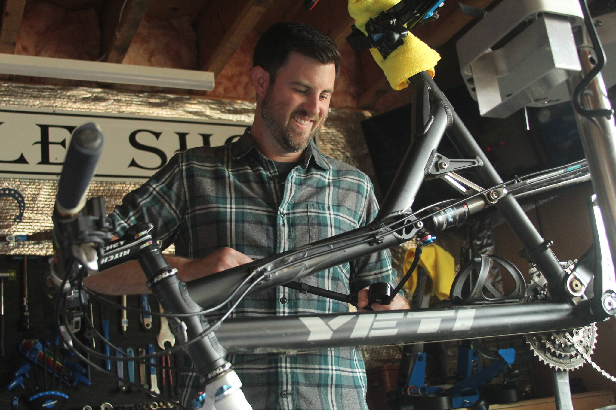 Photo by Karina Andrew/Whidbey News-Times
Trevor Stevens, owner of Celerity Cycles, fixes a bicycle in his home shop in Coupeville.