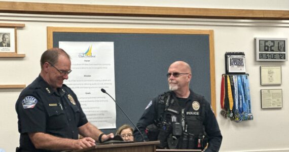 Photo provided
Oak Harbor Police Officer Mel Lolmaugh receives the Emergency Treatment Award at a city council meeting Sept. 5.