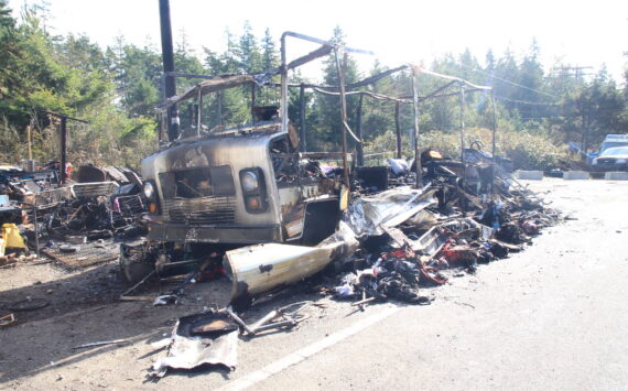 An RV was destroyed in a fire Sunday at a roadside homeless encampment. (Photo by Luisa Loi / Whidbey News-Times)