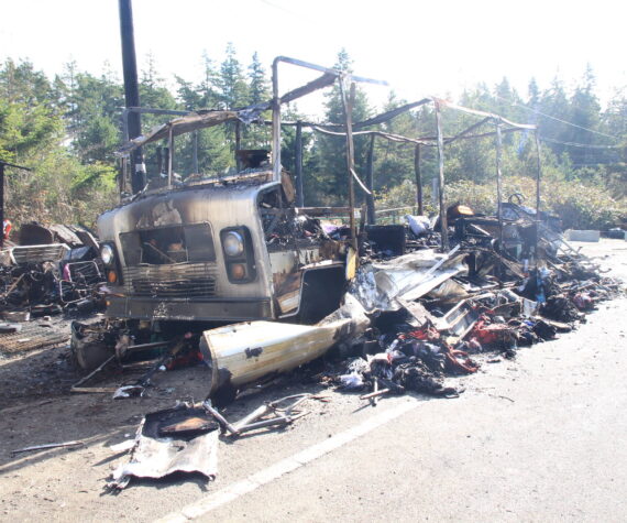 An RV was destroyed in a fire Sunday at a roadside homeless encampment. (Photo by Luisa Loi / Whidbey News-Times)